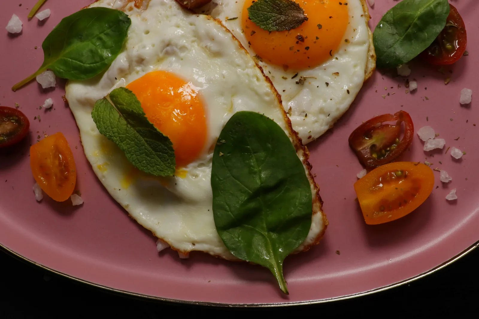 Eggs served with greens and tomatoes