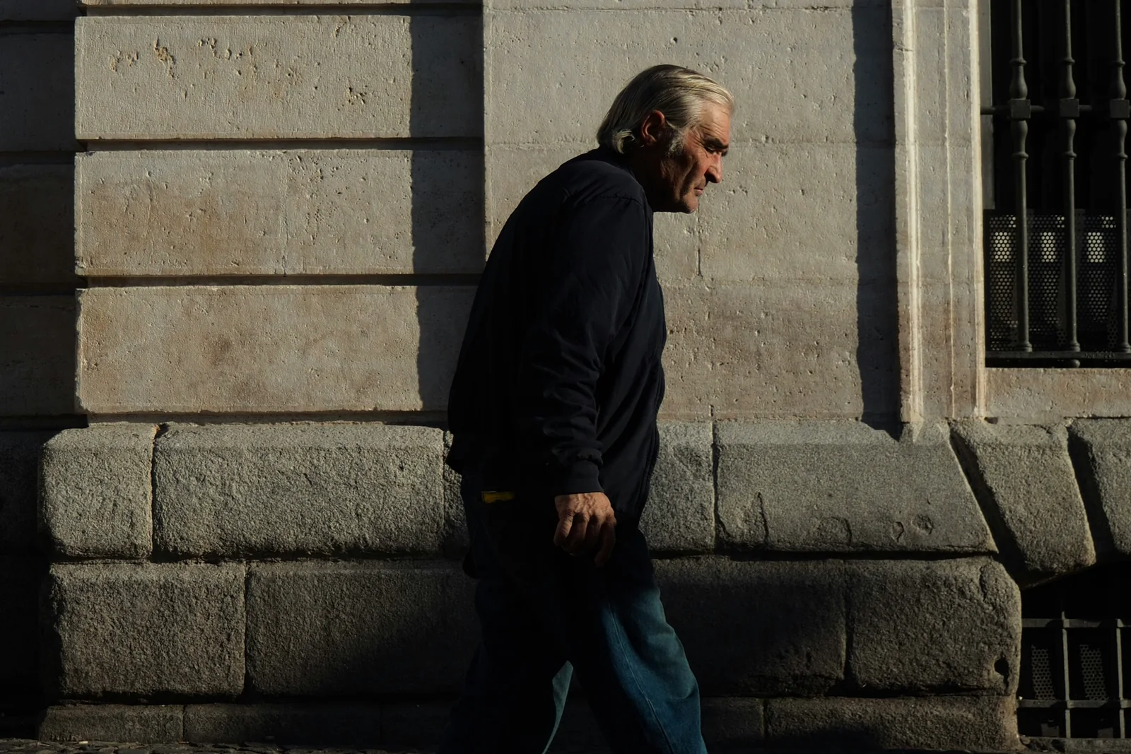 Older man taking a calm sunlit walk