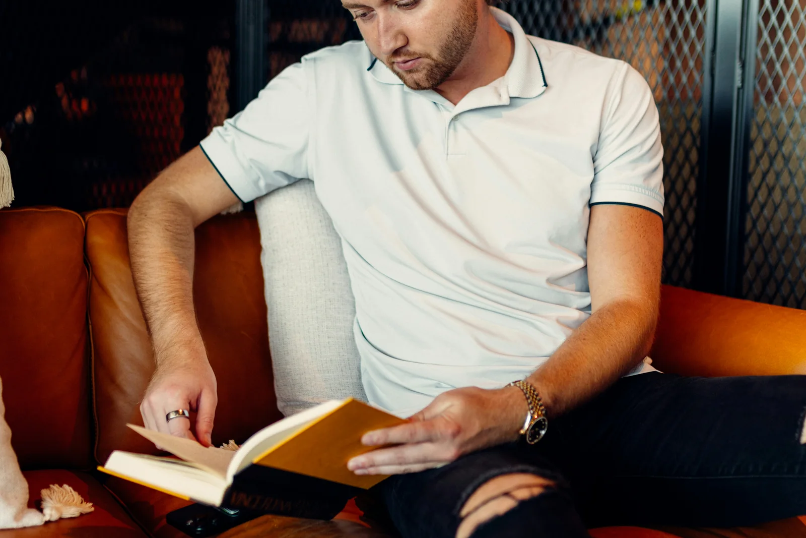 Man reading comfortably on a sofa